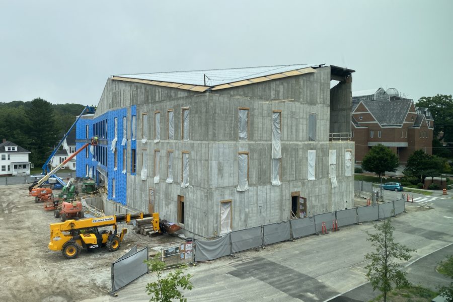 Seen from the third floor of Chu Hall, this July 10 view of the Bonney Science Center shows completed roof decking and, on the south wall, blueskin vapor barrier being applied. (Geoff Swift/Bates College)