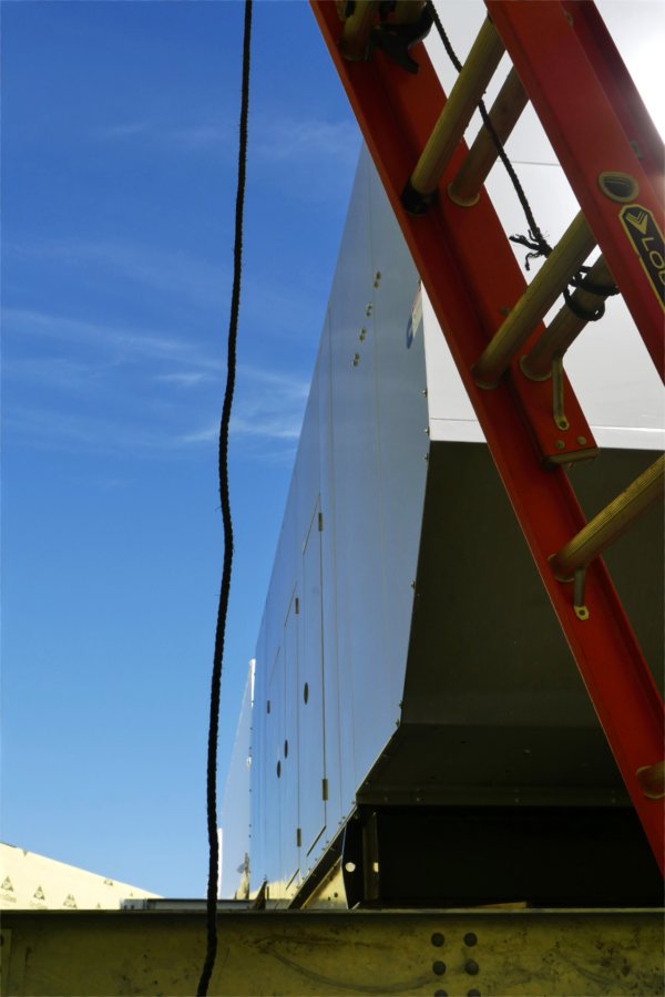 A peek at the Bonney center's emergency generator, sited in an open mechanical well atop the building. The generator and other mechanical units were hoisted to the Bonney penthouse on Aug. 17. (Doug Hubley for Bates College)