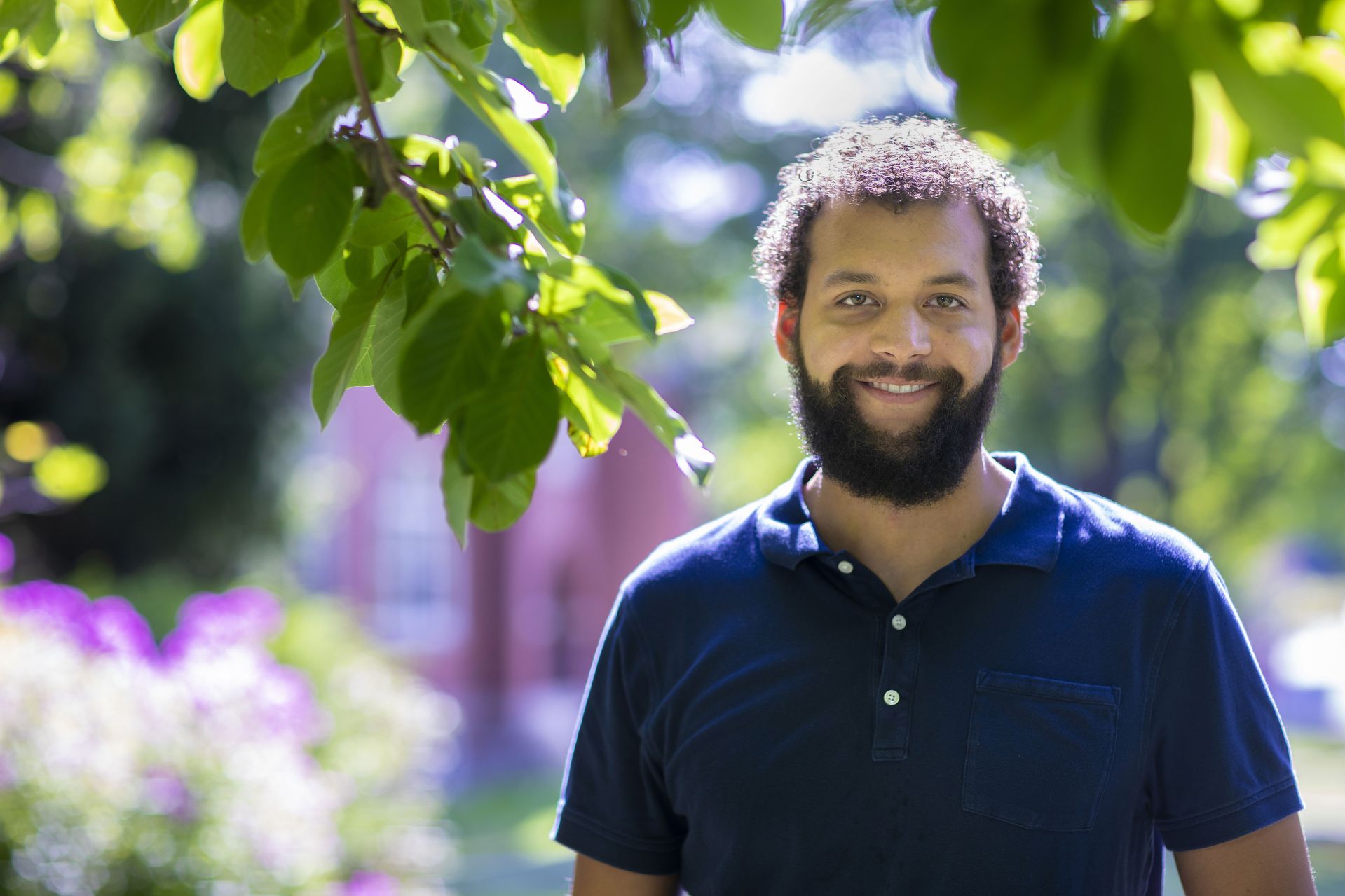 Assistant Professor of Environmental Studies Tyler Harper photographed on the historic Quad, on the steps of Hedge Hall and moving books into his Hedge Hall office on Aug. 14, 2020.