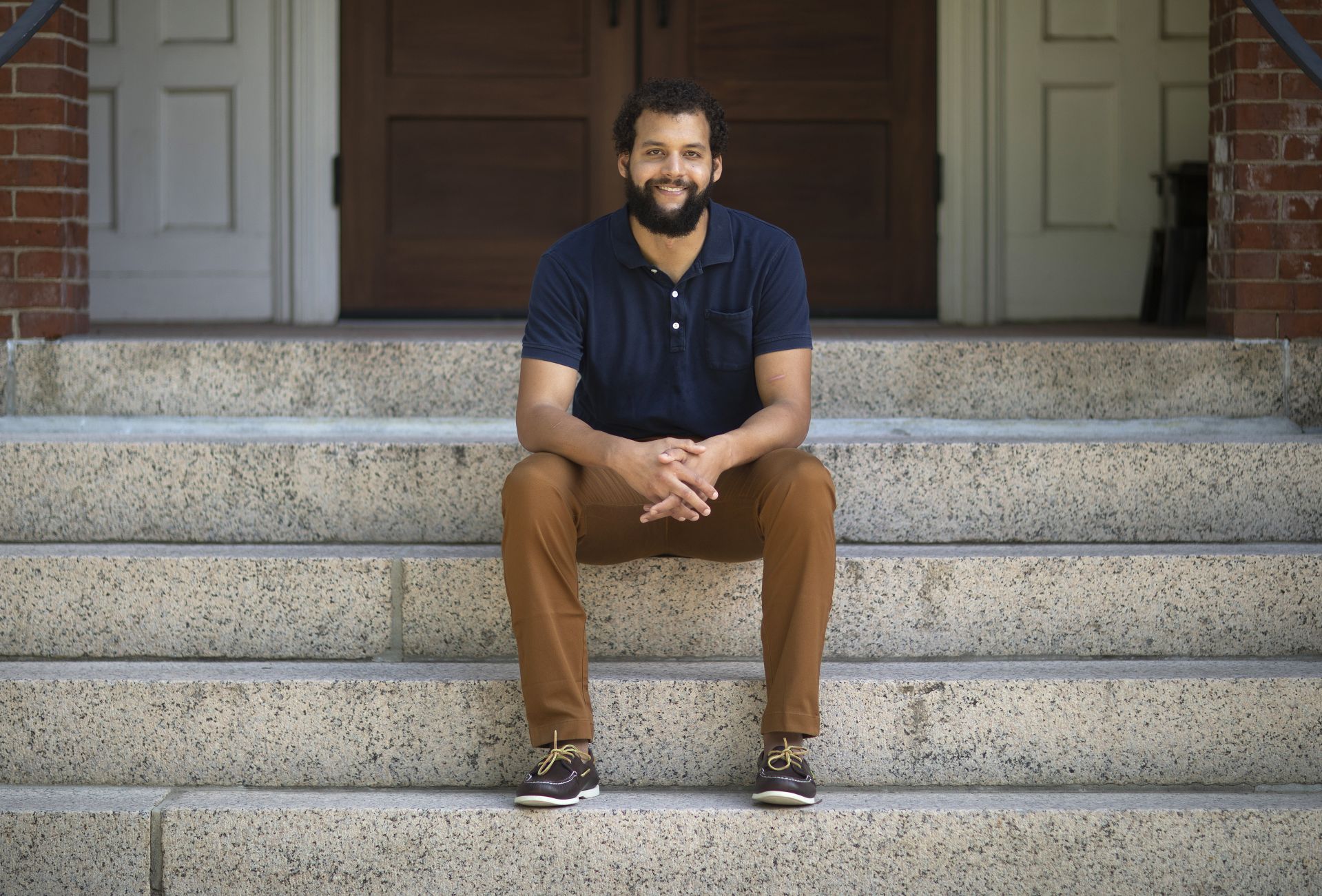 Assistant Professor of Environmental Studies Tyler Harper photographed on the historic Quad, on the steps of Hedge Hall and moving books into his Hedge Hall office on Aug. 14, 2020.