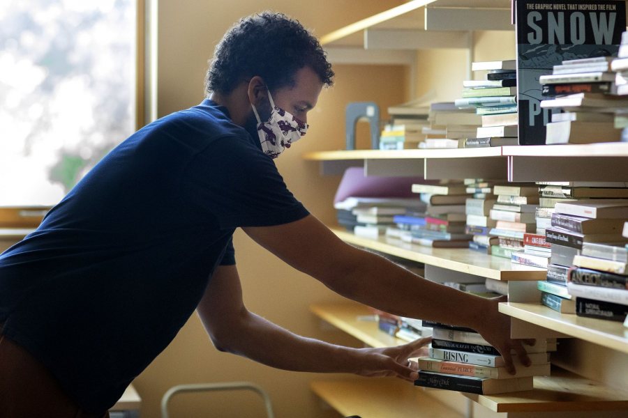 Assistant Professor of Environmental Studies Tyler Harper photographed on the historic Quad, on the steps of Hedge Hall and moving books into his Hedge Hall office on Aug. 14, 2020.