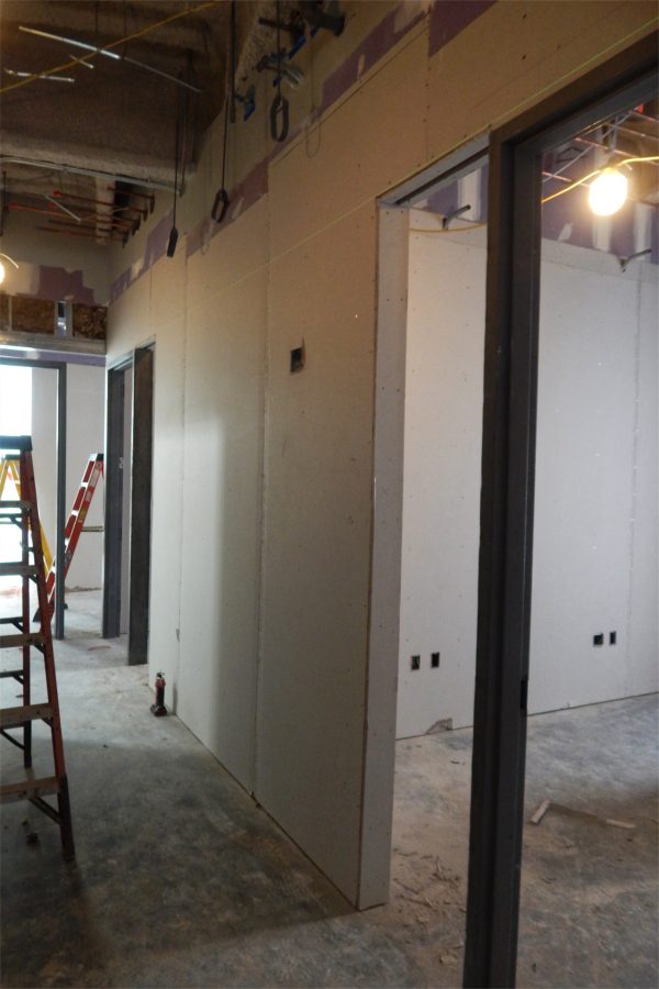 Paint and drywall are forming rooms and hallways from empty space. The opening to the left of the doorframe will hold a glass insert. (Doug Hubley/Bates College)