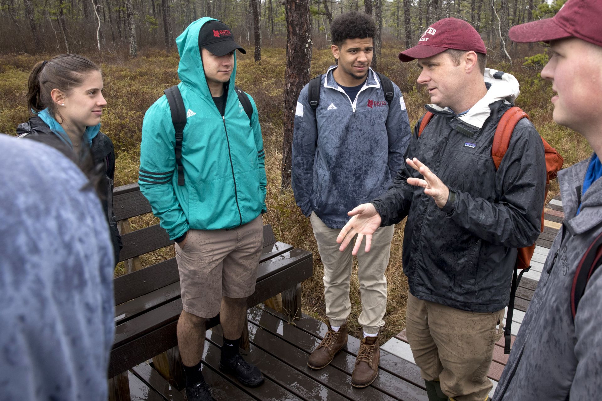 Assistant Professor of Biology Brett Huggett and eight students on Bio s37/ "North Woods" take a field trip on the second day of Short Term to the Saco Heath Preserve, managed by the Nature Conversancy in Saco, Maine, where they explored the bog habitat and participated in tree identification. 

Student IDs:

In photograph with Huggett kneeling in font and students lined up facing him, from left to right:

Charlotte "Karly" Oettgen '19 of Wellesley, Mass. (black jacket, Bates hat)

Sara Buscher '19 of Falmouth, Mass. (black jacket, pony tail)

Isabella Del Priore '19 of Cos Cob, Conn. (black jacket, braids)

Gabriel Benson '20 of Maplewood, N.J. 

Tyler Sorkin '18 of Raymond, N.H., (blue jacket, shorts)

Marcus Ross '19 of Arlington, Texas (gray jacket, no hat)

Nathaniel Friesth '17 of Mumford, Tenn. (gray jacket, bates hat)

Robert "Bobby"  Dee '19 of Plymouth, Mass. (bright green jacket)