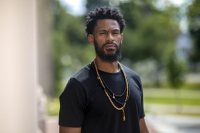 Michael Boyd Roman - Mellon Postdoctoral Fellow and Lecturer in Art and Visual Culture, posing on the historic Quad on Aug. 21, 2020.