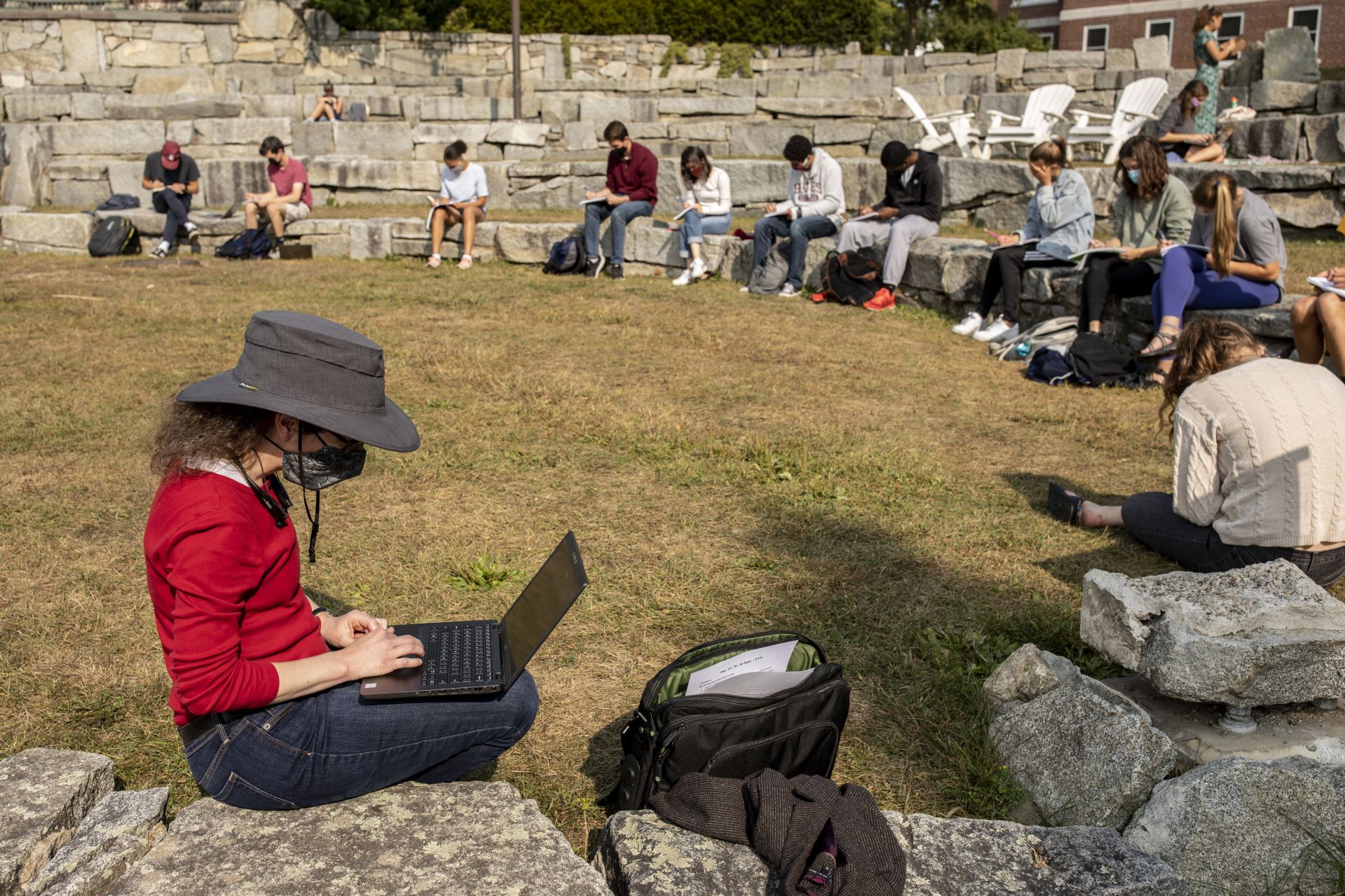 Assistant Professor of Biology Carla Essenberg teaches her first-year seminar, seated on the Keigwin Amphitheatre. They were asked to circle Lake Andrews in order to make written observations.FYS 508 - Nature through Human EyesAlthough our connections to the rest of nature may be hidden from us, we remain reliant on a complex network of interactions with other species. As we shape their environments, other species influence us in turn, feeding us, protecting us, destroying, sustaining, and inspiring us. How are we to understand the living world of which we are a part? In this seminar, students explore different ways of learning about other species, with a particular emphasis on scientific methods, and communicate what they have learned through a variety of genres.