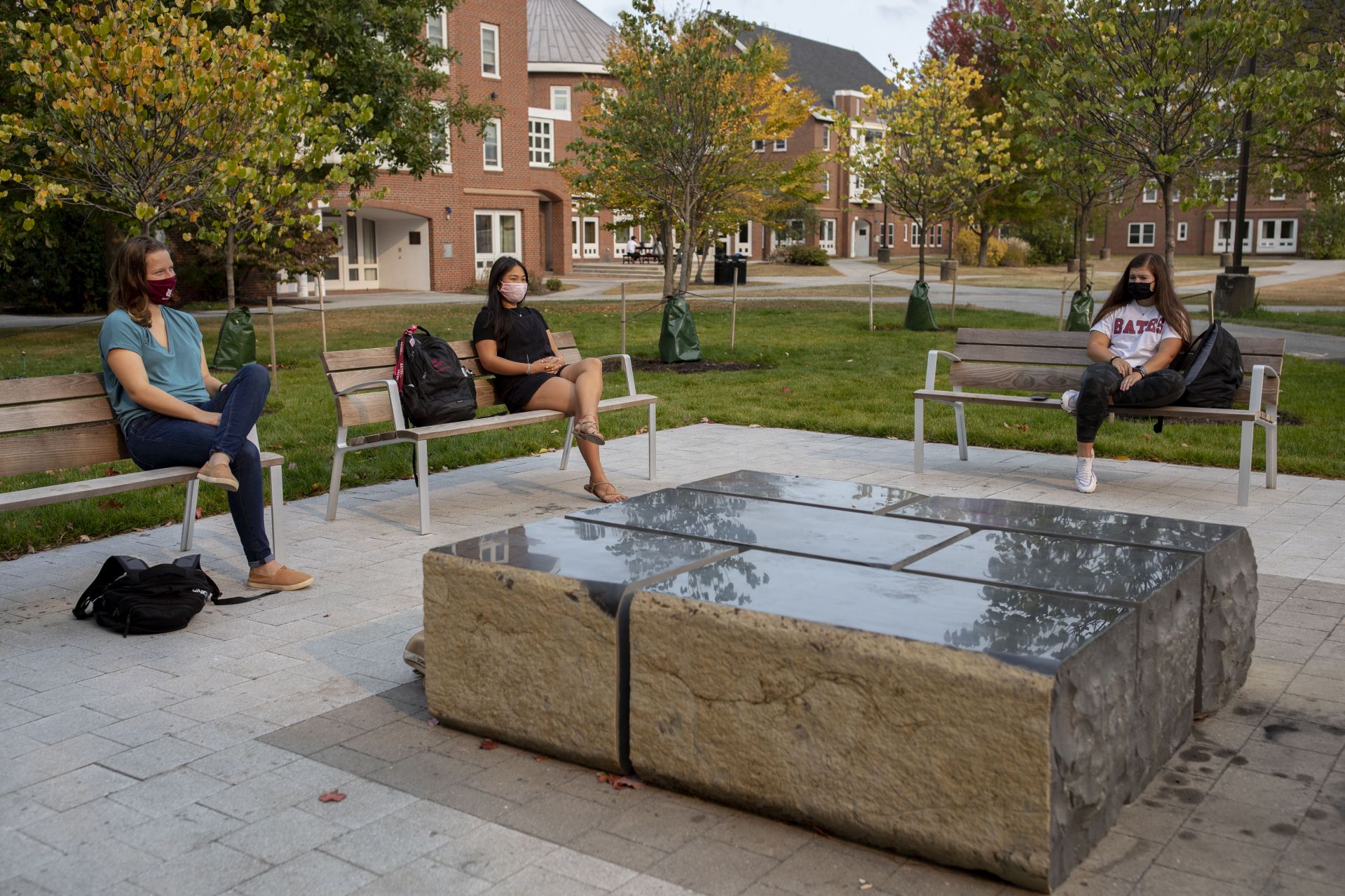 Sunday afternoon, Sept. 27, 2020, at or adjacent to the Veterans Plaza.

Janell Sato '22 of Honolulu, Hawaii, in black shirt, sits in reflection with friends Amanda Taylor '23 of Fair Lawn, N.J. (Bates shirt), Mary Colette '21 (blue shirt)  of Watertown, Conn., and Michael Ratsimbazafy '22 of Elizabeth, N.J., on the Veterans Plaza.