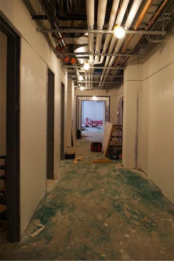 This first-floor corridor leads through a section of storerooms. The green stuff on the floor is sweeping compound. (Doug Hubley/Bates College)