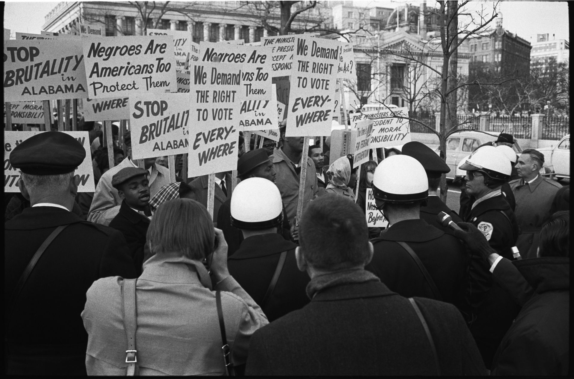 [African American demonstrators outside the White House, with signs "We demand the right to vote, everywhere" and signs protesting police brutality against civil rights demonstrators in Selma, Alabama] / WKL.

Leffler, Warren K, photographer. African American demonstrators outside the White House, with signs "We demand the right to vote, everywhere" and signs protesting police brutality against civil rights demonstrators in Selma, Alabama / WKL. Alabama Selma Washington Washington D.C, 1965. Photograph. https://www.loc.gov/item/2014645538/.