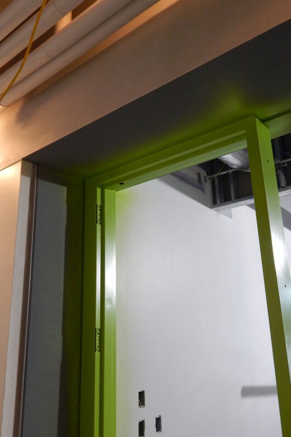 The green and gray around this first-floor doorway are finish coats of paint. The "peach" is actually white primer, color-shifted by the camera. (Doug Hubley/Bates College)