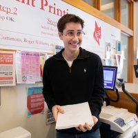 Jonathan Farrell '20 binds his creative writing yearlong thesis, a series of short stories, written under the guidance of his adviser, Jessica Anthony. He gathered a group of friends in the library at 10 a.m. on Saturday morning to bind his thesis (not quite done but close enough) to find closure. And he asked his friend Stevens "Steve" Shea '22 of Wilson, Wyoming.“It’s weird. Like, I feel like this was something kind of last minute, that I wanted to bind in the end. But they kind of gave me the closure I was so desperately looking for. And since, this thesis isn't really just a semester or year- long like mine was in the end, but it's kind of like all these stories are the amalgamation of my entire time here at Bates and something that I've been fortunate enough to write, and looking back reminded me of everything I've been through. The themes are kind of centered around, are kind of themed around an idea of loneliness and how characters try to cope with that. One of the stories is about a guy sitting upon a chapel kind of rooftop talking to gargoyles. Another one is a guy trying to think about how you can get a goldfish out of his toilet, and his goldfish is like almost a plastic God sort of thing. Yes, the characters cope with their own loneliness and they move forward. Great.Steve has become a really good friend of mine this year. I met him at the beginning of the year, and I didn't really know him at first, but we were rock climbing together. He was always around a lot when I was working on my thesis, which was Saturday nights when the deadline was Sunday morning. And whatever I would write about it, like Johnny, ‘it's all good.’ Like, ‘don't worry about it. You know, you're writing You're doing well.’ You're like, ‘just keep on going.’ And that was something I was so kind of thankful for.”“It's definitely weird that we're all done. I mean, so many seniors are now off campus. And we kind of, I've been thinking a lot like, you know,