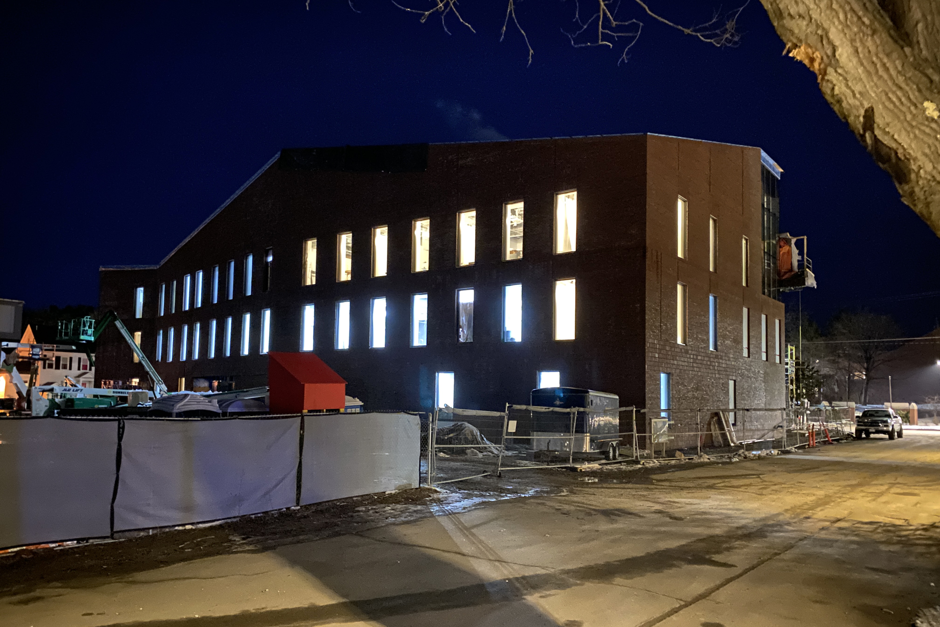 At 5:30 p.m. on Jan. 15, the Bonney Science Center is a bright spot on the edge of campus as painters, flooring installers, and other trades work the evening shift. (Geoff Swift/Bates College)