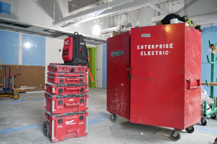 Known as "gang boxes," rolling cabinets like the one at right serve as portable offices for subcontractors. A first-floor Bonney Center classroom houses this Enterprise Electric gear. (Doug Hubley/Bates College)