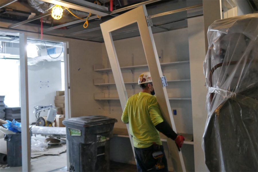 Wrangling a new door on the Bonney center's second floor. (Doug Hubley/Bates College)