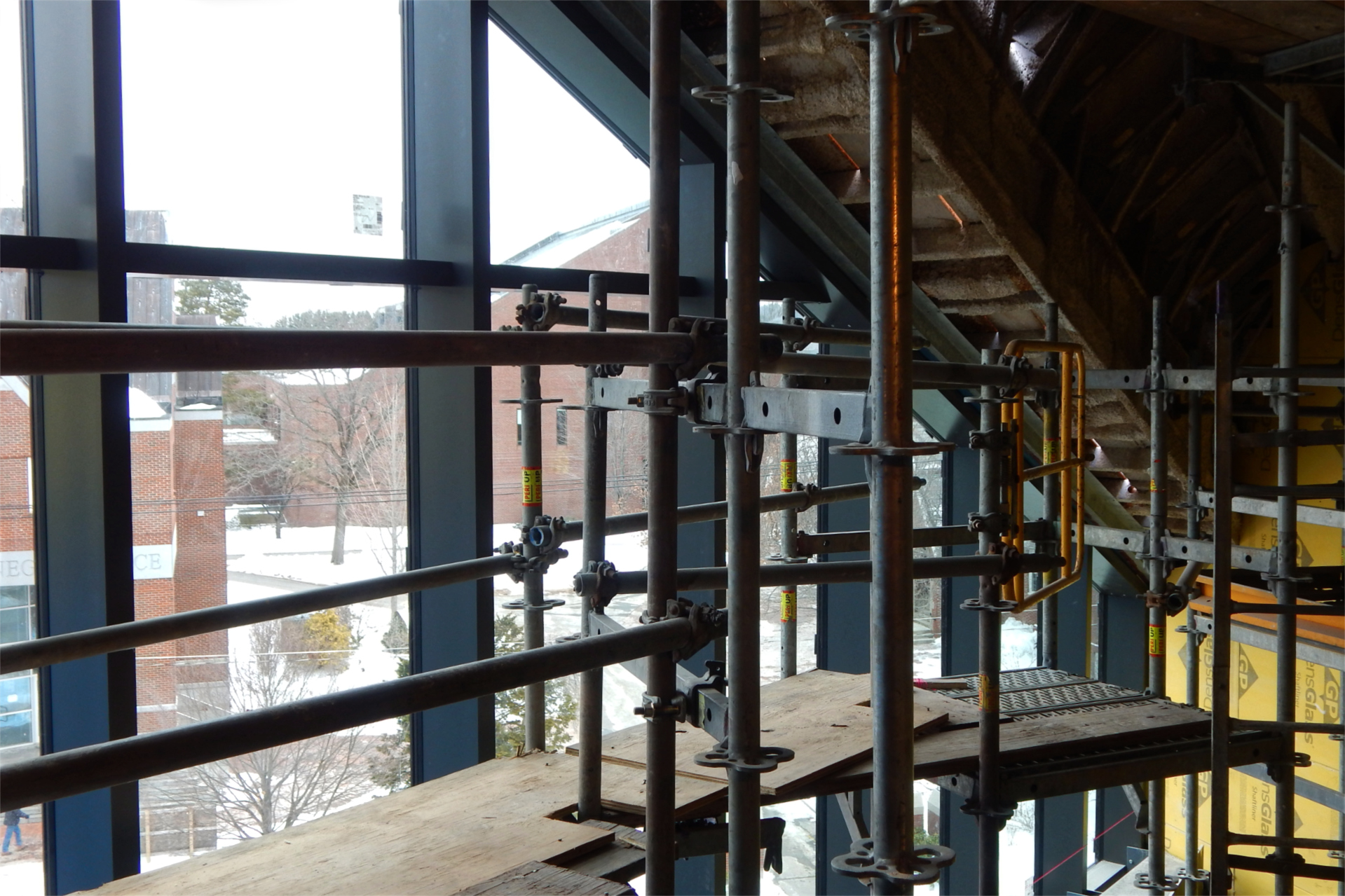 This staging on the third level of the Bonney Science Center gives glassworkers and other access to the  glass curtain wall. Ladd Library and the Carnegie–Chase Hall courtyard are visible at left. (Doug Hubley/Bates College)