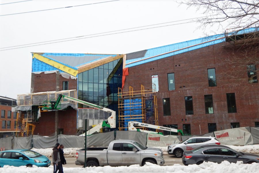 With brickwork largely complete and most of the Monumental Stair curtain-wall glass in place, the Bonney Center is shown from across Campus Avenue on Feb. 15, 2021. (Doug Hubley/Bates College)