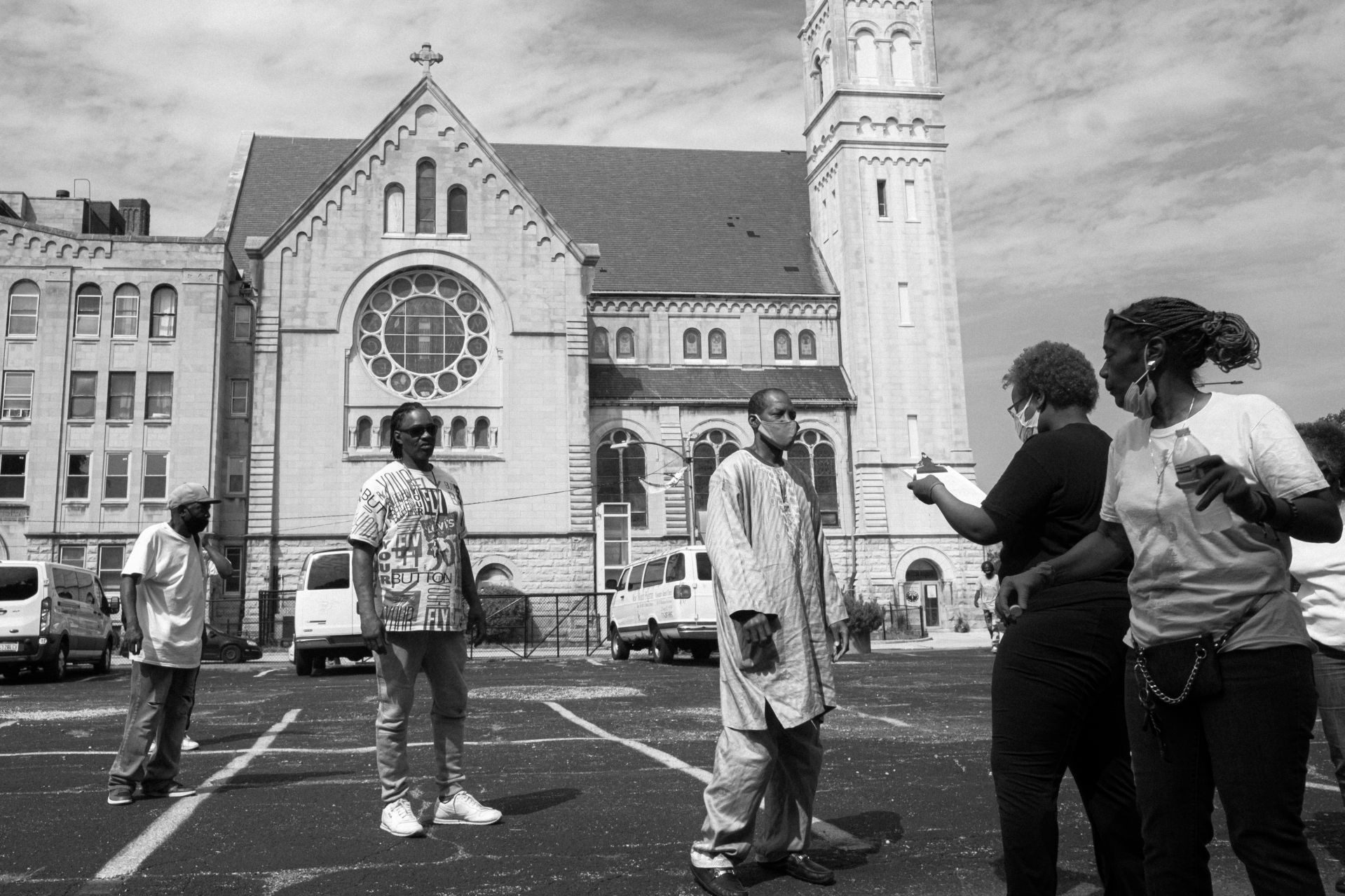 Members of Chicago’s West Garfield Park neighborhood stand in line as volunteers record information during a food and PPE (Personal Protection Equipment) drive at New Mount Missionary Pilgrim Baptist Church. August 7, 2020.