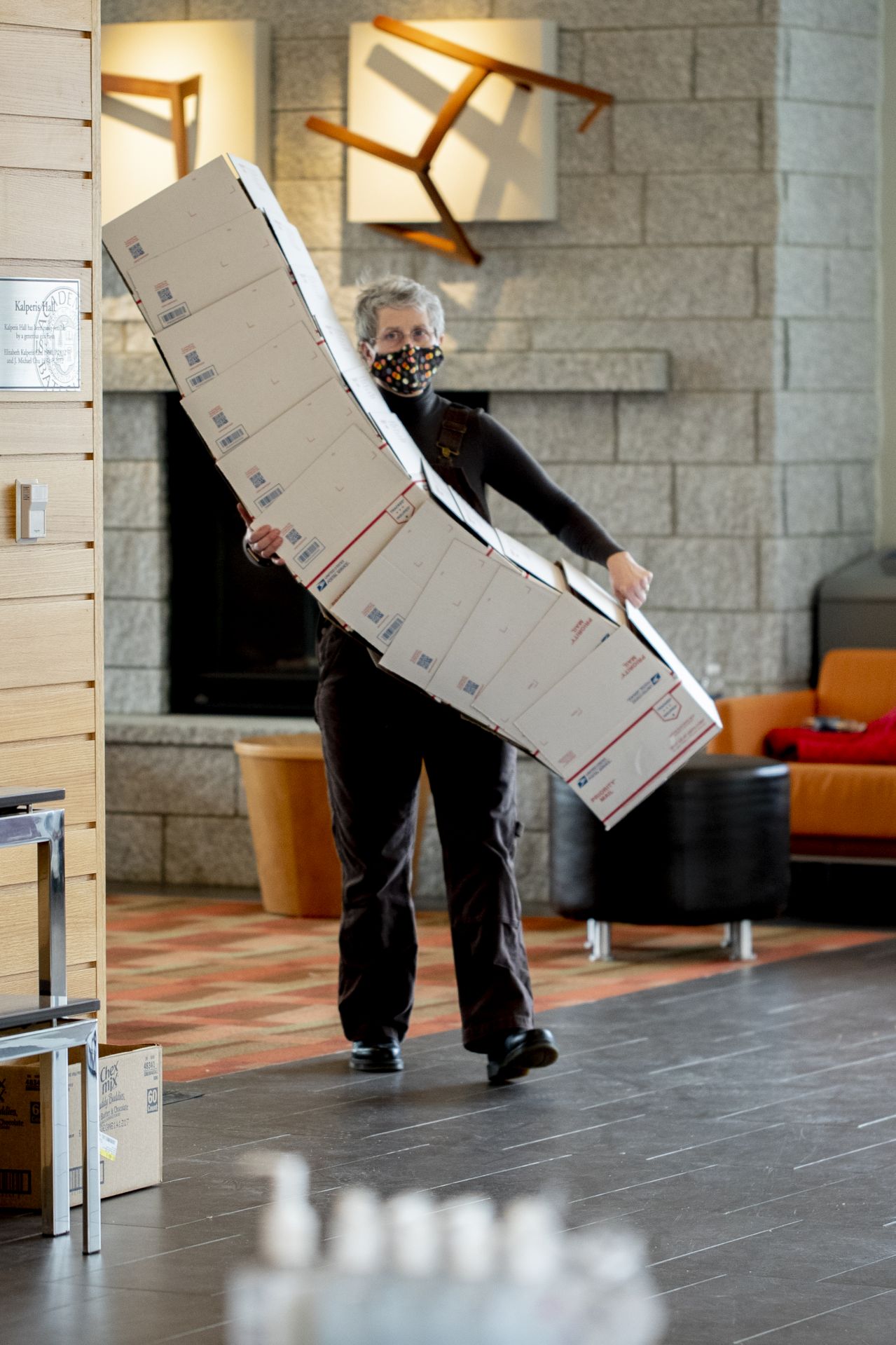 Bates staff, under the supervision of Assistant Vice President for Dining, Conferences, and Campus Events Christine Schwartz, form an assembly line in the Bates College Store to pack and ship Commencement boxes for members of the Class of 2020 on Tuesday, April 28, 2020.