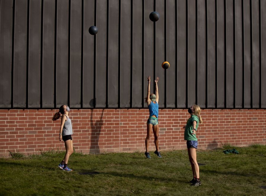 Women's cross country team gathers for warm-up exercises before heading out for a run under supervision of  Jennifer L. Hartshorn, Lecturer in Physical Education, and Arthur Feeley, Assistant Cross Country and Track & Field Coach