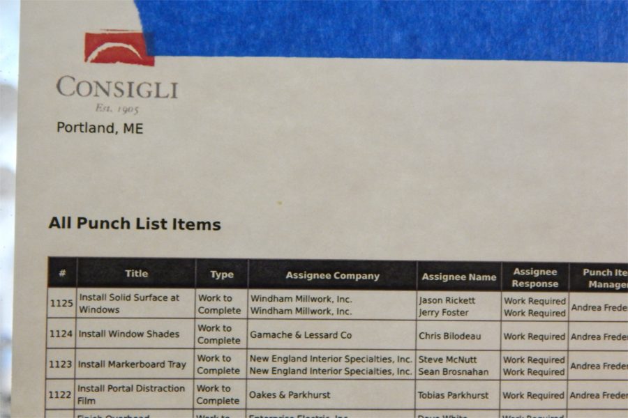 Posted outside a classroom on the second floor of the Bonney Center, this list details "work to complete" items and the subcontractors and individuals responsible for them. Despite the list heading, the "work to complete" phase precedes doing punch lists on a project. The list is among information that can be called up by scanning a QR code assigned to the room. (Doug Hubley/Bates College)