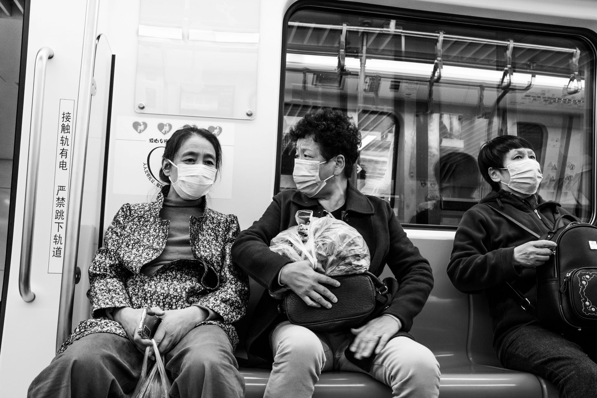 Metro riders wear masks in Qingdao, China, in November 2020. (Photograph by Gauthier Delecroix)
