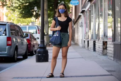 "Despite working remotely this summer, I’ve been glad to still be able to engage with the community a bit in-person like this.” —Anthropology major and Bonner Leader Hannah McKenzie of Stevenson, Md., photographed on Lewiston’s Lisbon Street and in the Heritage Restaurant and its adjacent market place, where she regularly shops and purchases tea. This summer, McKenzie has divided her time between two local organizations providing support to refugees and immigrants: the Immigrant Resource Center of Maine and Immigrant Legal Advocacy Project. The tea she purchases at the Heritage Restaurant, says Mckenzie “reminds me of one of the first cultural lessons I learned in Lewiston.” When Hamza Abdi, a community leader and an academic administrative assistant at Bates and she first started teaching an IRCM English class together her first semester at Bates, “Hamza would leave in the middle of each class to retrieve us each traditional Somali tea, flavored with spices like cinnamon and cardamom and sweetened in condensed milk. I loved this tea,” she says. “Only three months into teaching did I realize Hamza had been buying the tea from this restaurant downstairs, rather than making it in the office break room as I had assumed. I contested that I didn’t want him spending his money on me — after all, if I come to the Center twice weekly for four years, that’s a lot of money. Hamza laughed, well versed in the differences between our cultures. He explained that in Djiboutian culture, money is considered best used for gestures of sharing and showing others appreciation. Someone in his culture doesn’t ‘lose’ money, as people essentially take turns paying for their friends.” These days, Mckenzie regularly picks up tea at the Heritage Restaurant. “I really appreciate the culture of collectivity that surrounds it. These kind of cultural lessons are what have made my experience of Lewiston and my studies of anthropology at Bates so eye-opening a