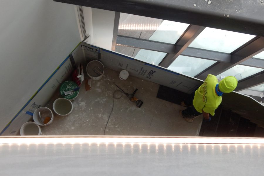 A Pavilion Floors employee is shown from the third-story overlook in the Beacon. Note the light fixture across the front of the overlook. (Doug Hubley/Bates College)