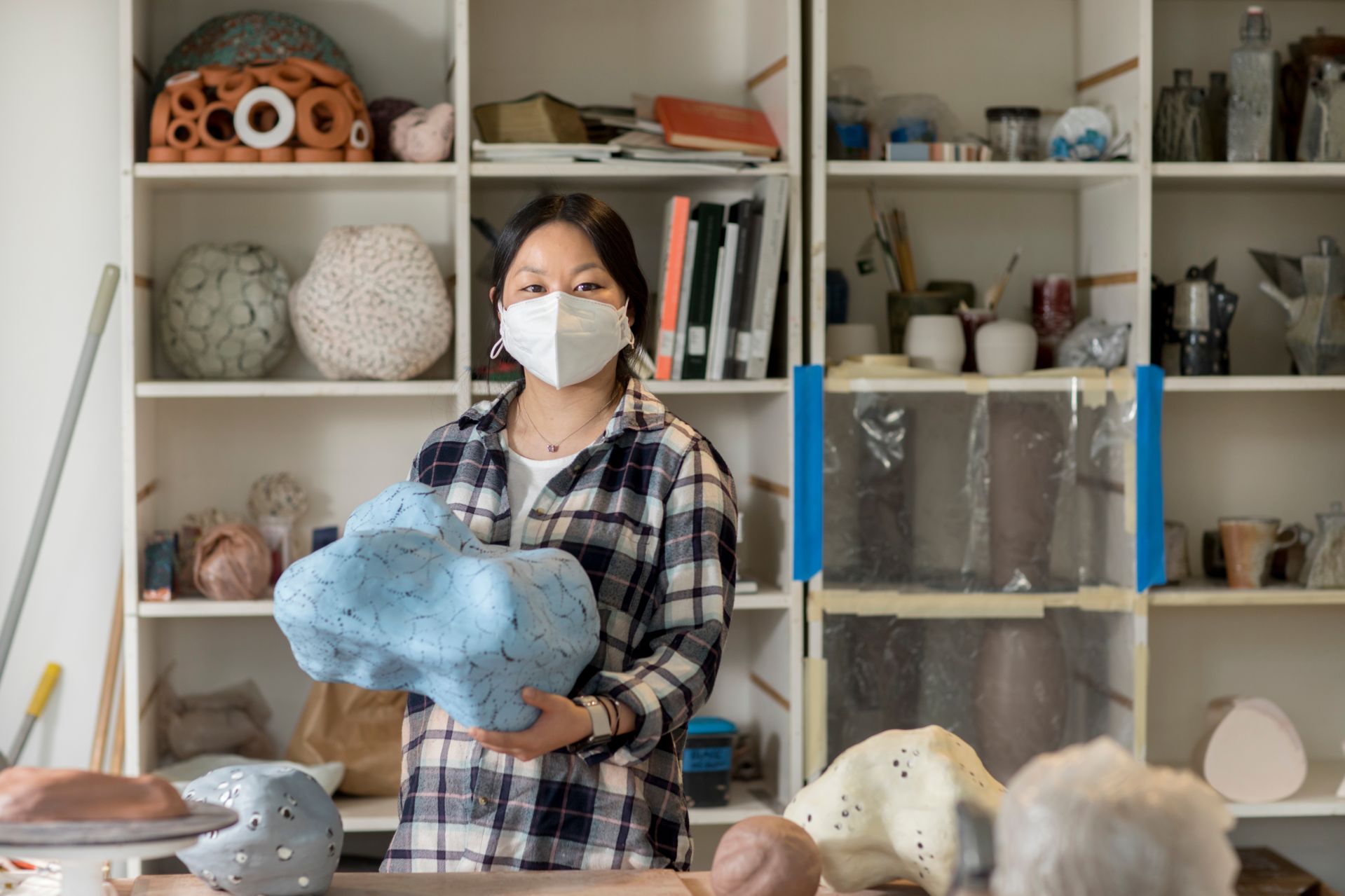 Studio art major Laila Stevens '21 of Norwich, Vt., ., poses in her Olin Arts Center studio (Room 132) on April 19, 2021. She is a ceramicist.