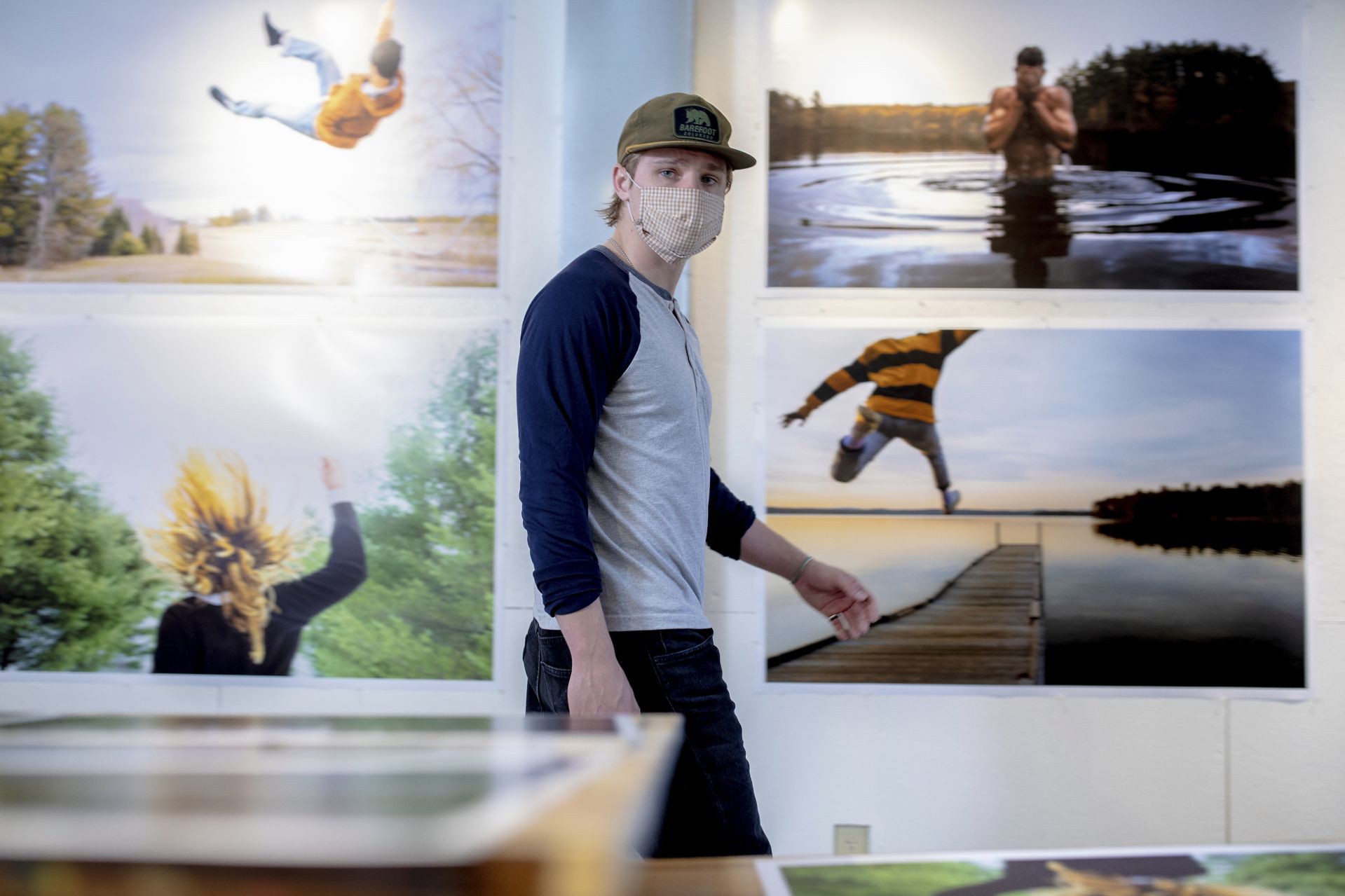 Blaise Marceau '21 of Waban, Mass., in his Olin Arts studio, paces in front of some of his work prints for his senior exhibition.