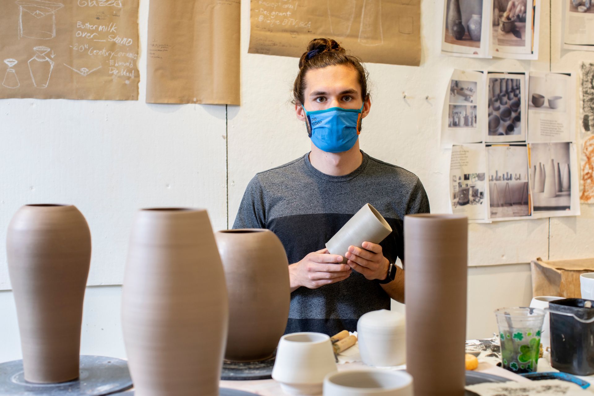 Christopher Barker '21 of Burlington, Vt., poses and works in his Olin Arts Studio Room 132. His ceramics will be on display in the annual senior exhibition in the Bates Museum of Art.