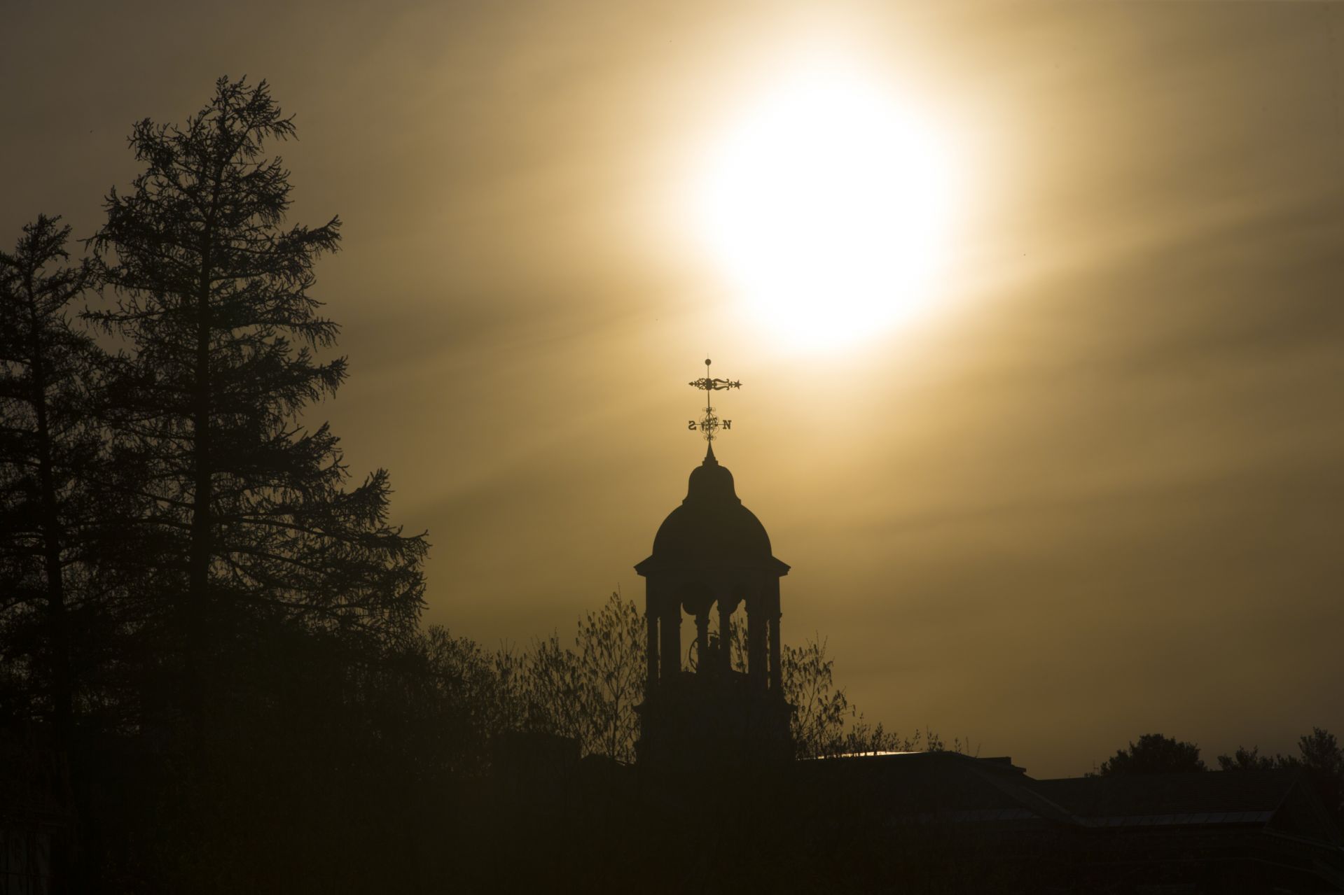 Sun sets behind Hathorn Hall.