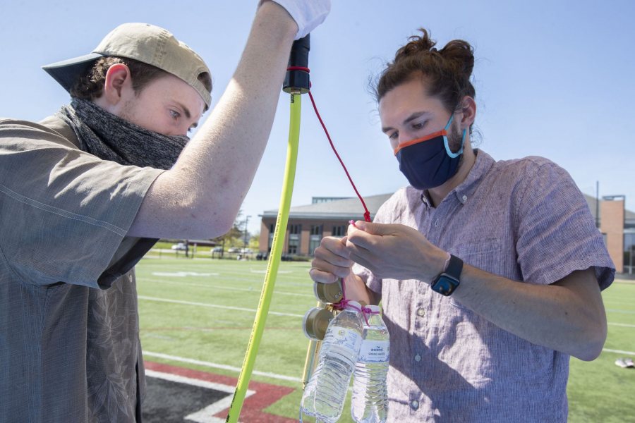 Donahue and Barker attach a counterweight to the balloon in preparation for removing the gas hose. "The counterweight makes the balloon easier to hold as it builds lift and helps with measuring the positive lift reading as we aim for our target lift value to stay close to the predicted launch path," explains Barker.