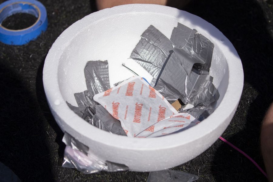 The payload capsule, a hollow styrofoam sphere, had high- and low-tech gear, the latter being hand warmers to help keep the high-tech gear running in cold high-altitude conditions. (Phyllis Graber Jensen/Bates College)