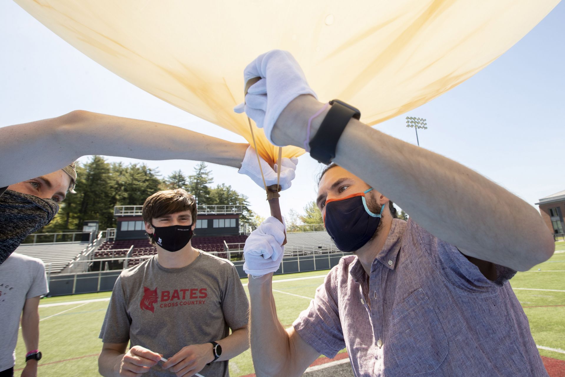 The gas hose removed, Barker ties off the balloon. (Phyllis Graber Jensen/Bates College)