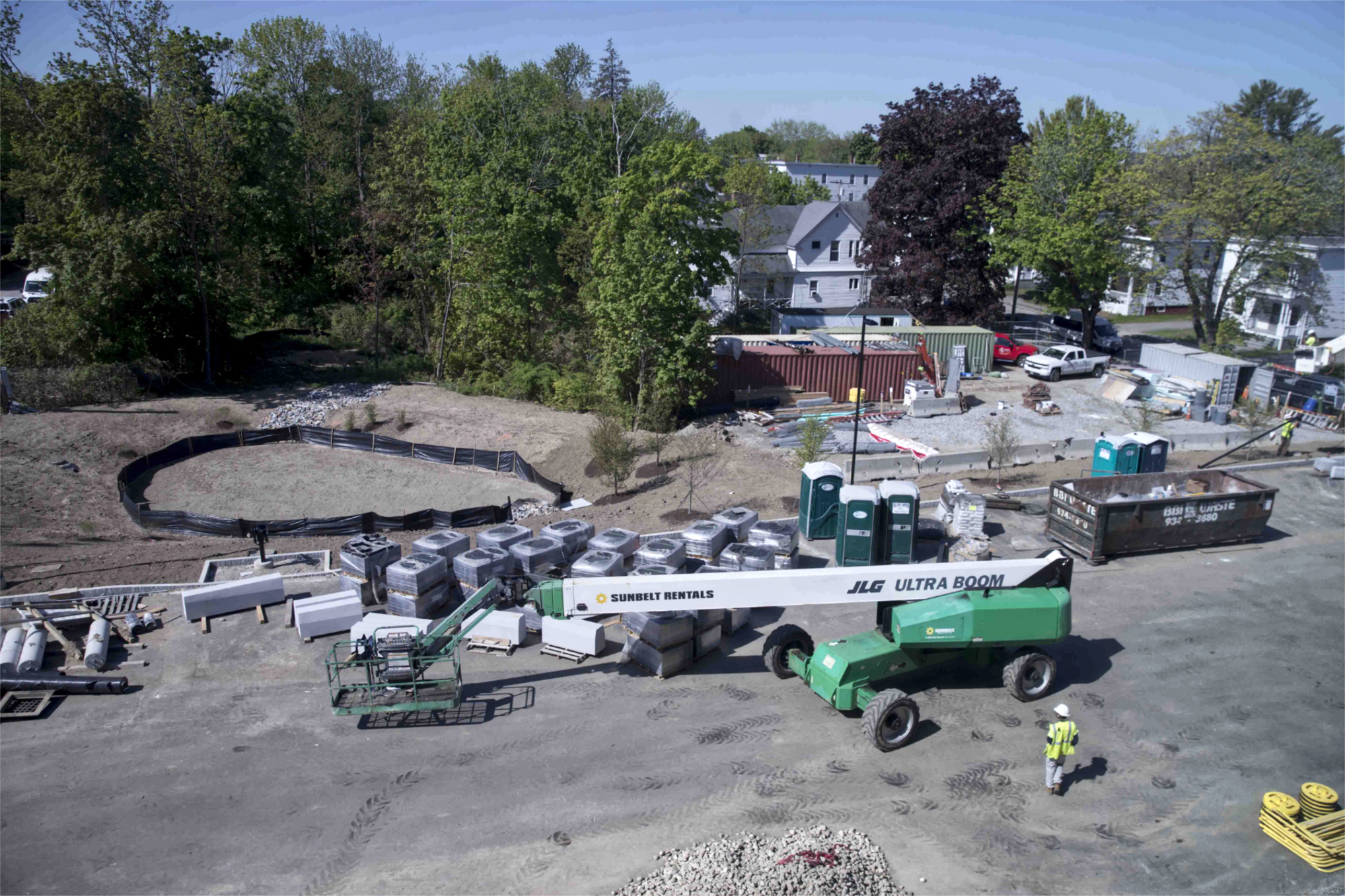 The south side of the Bonney Science Center lot is shown from the roof on May 17. Note the stormwater detention basin at left and the pallets of hardscaping materials. The leftmost of the Jersey barriers is near the former site of the Campus Construction Update penthouse. (Phyllis Graber Jensen/Bates College)