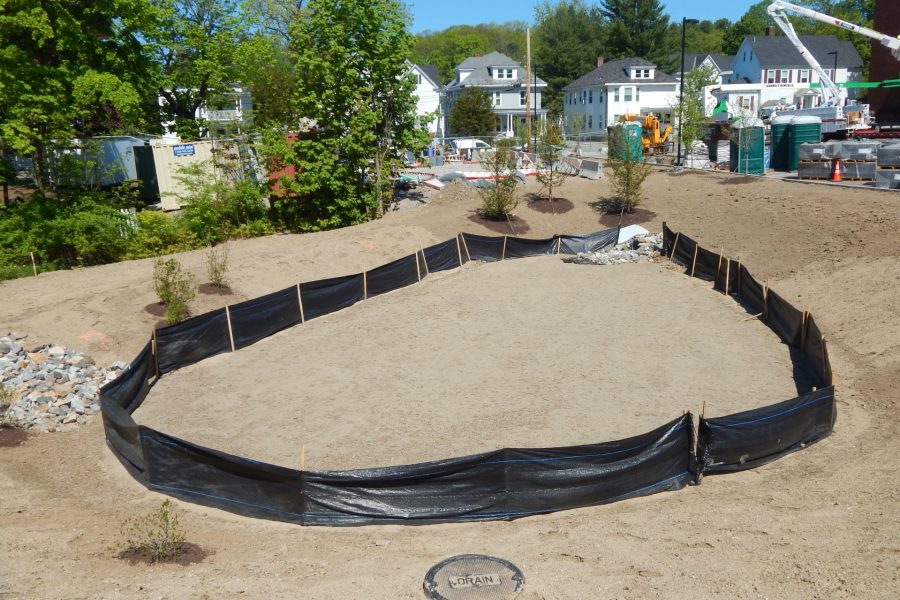 The freshly contoured runoff basin at the back of the Bonney Center lot. Storm runoff will be routed through the basin to slow surges of water into the municipal stormwater system. (Doug Hubley/Bates College)