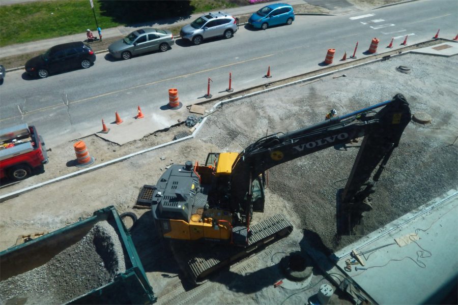 Shown from a third-floor window, an excavator spreads subsoil in front of the science center. (Doug Hubley/Bates College)