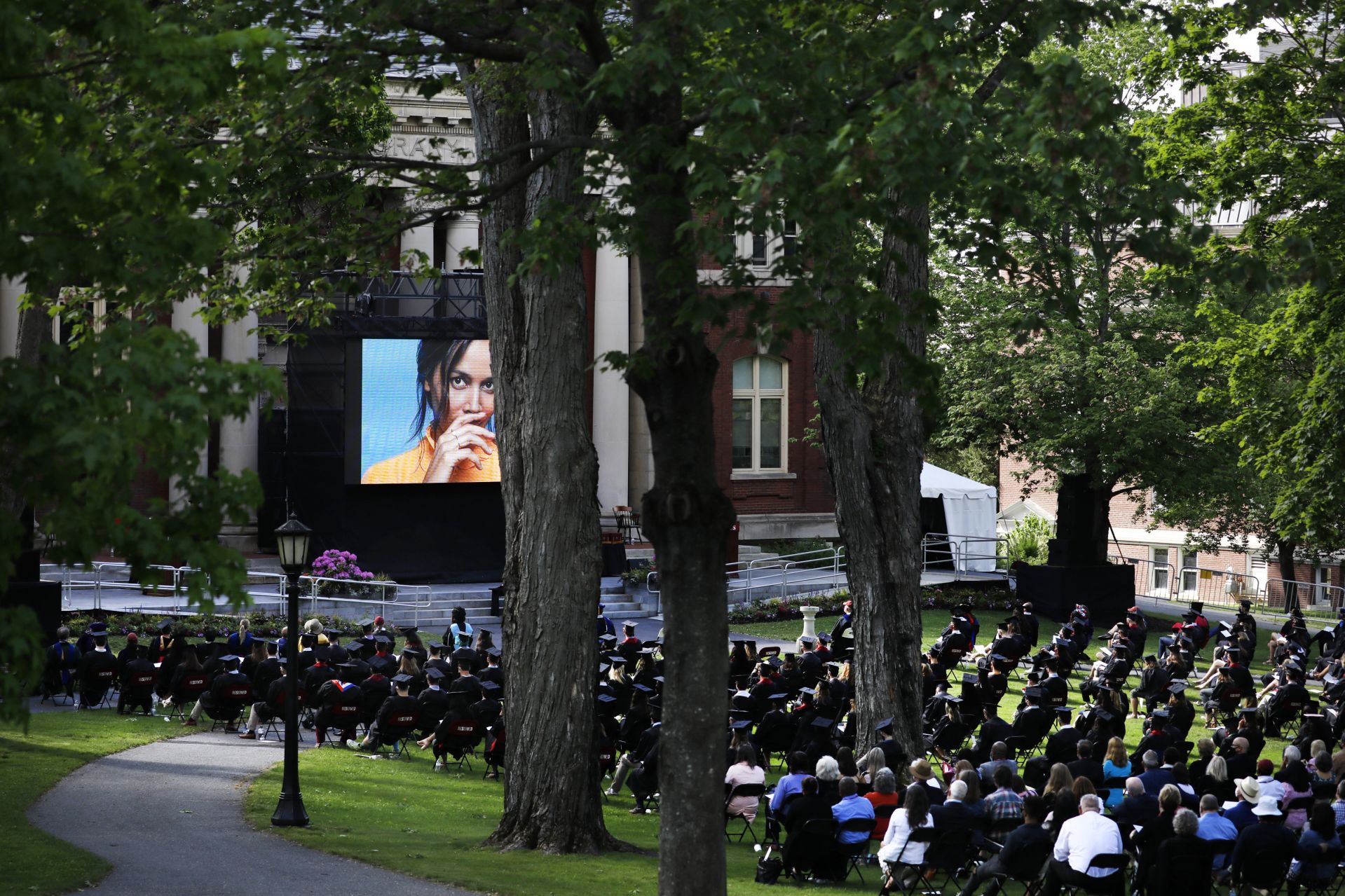 During the morning Commencement ceremony on May 27, 2021, the video monitor on the Coram Library Terrace displays a photograph of Rhiannon Giddens as her honorary degree citation is read. (Theophil Syslo/Bates College)
