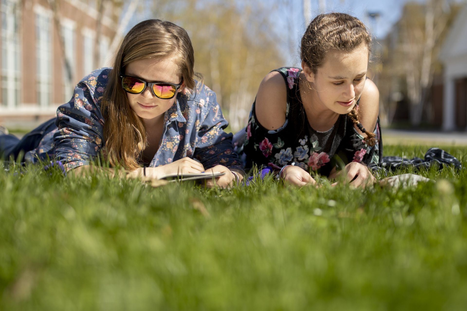 A beautiful spring day in May on Alumni walk where from left, Charlotte Collins '22 and Cathering Butler '22 enjoy "he perfect opportunity to read books for pleasure," says Butler.