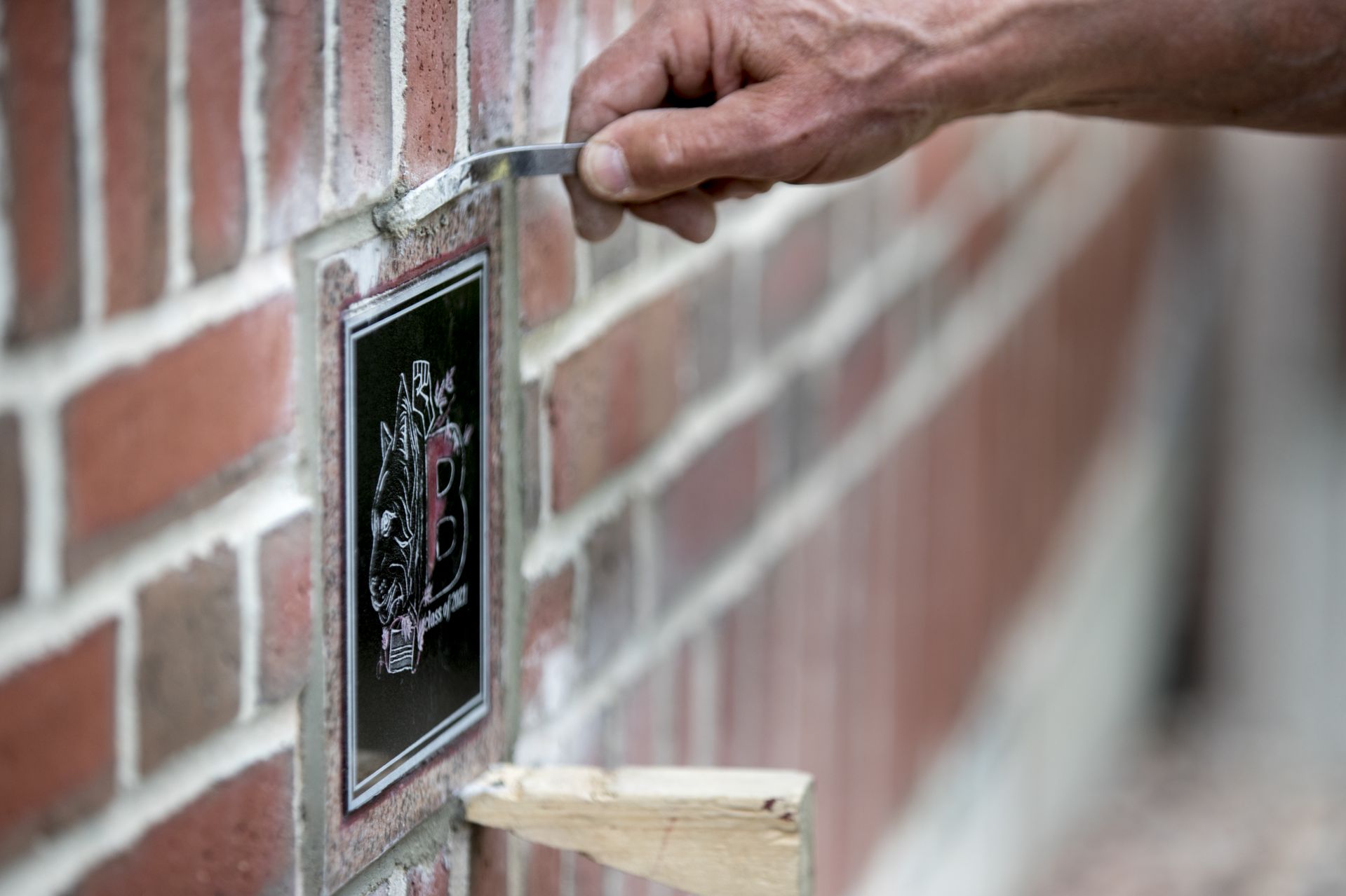 Muskan VermaÊ'21 of Shimla, India, designed the Class of 2021 Ivy Stone that Bates mason Ron Tardif installed to the right of the front door entrance to Pettengill Hall.