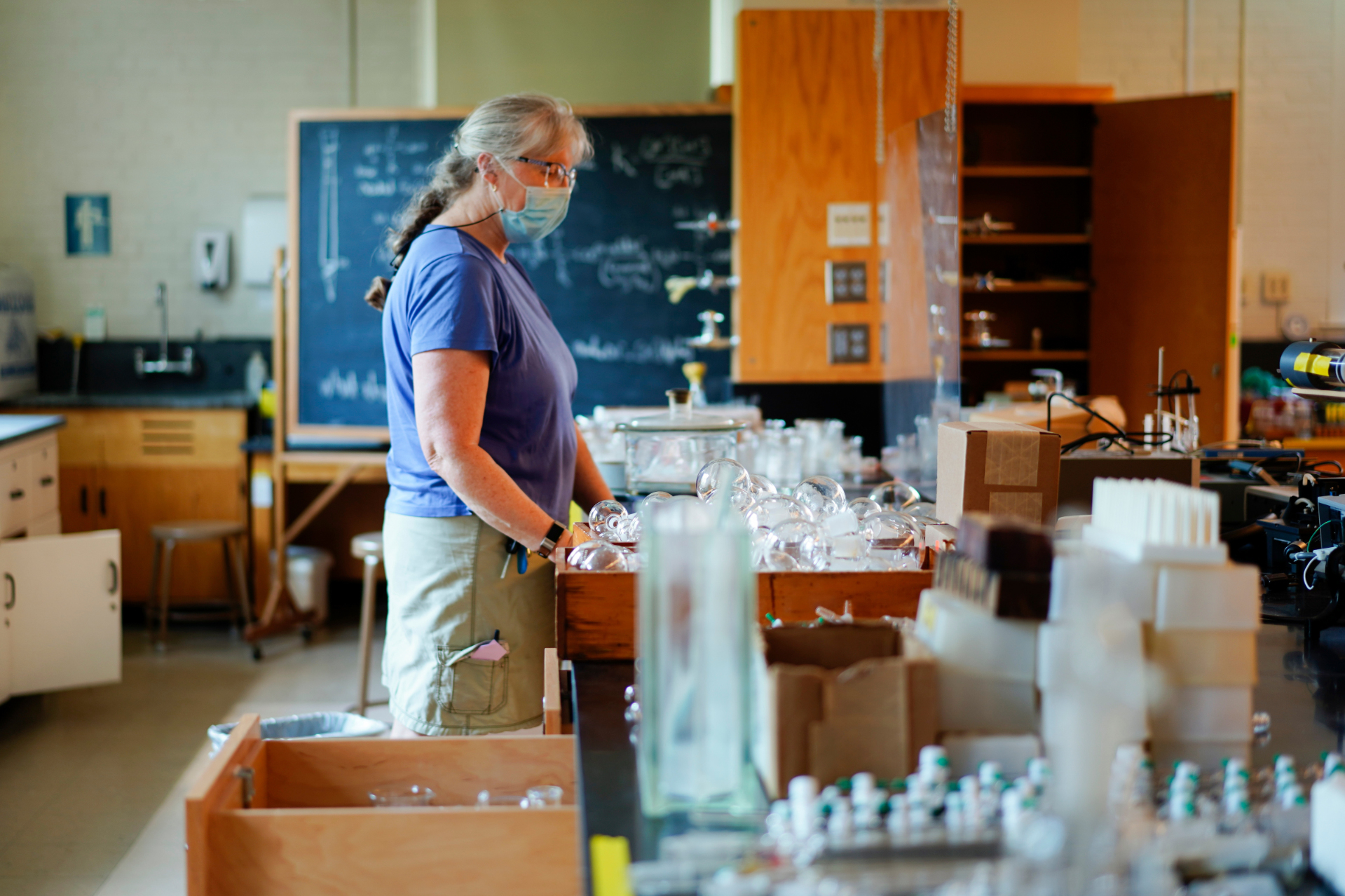 Lorna Clark, in her 30th year of employment with Bates as an assistant in instruction with the departments of chemistry and biochemistry, packs up glassware in the advanced chemistry laboratory on Dana Chemistry Hall's third floor. (Phyllis Graber Jensen/Bates College)