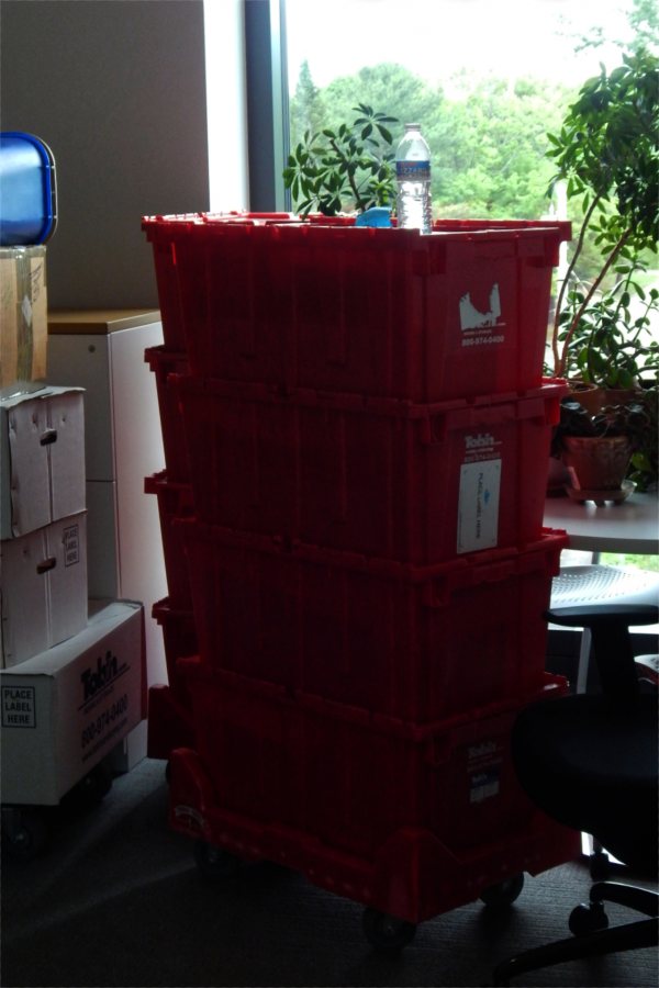 Totes and cartons awaiting unpacking by a member of the chemistry faculty. (Doug Hubley/Bates College)