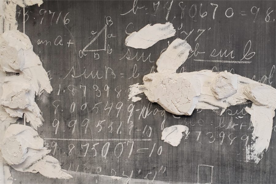 Still bearing notes from the last time it was used, this slate chalkboard appears to date back to the construction of Hathorn Hall, in the 1850s. With a replacement chalkboard mounted in front of it on some unknown date, the plaster smeared on it kept the new board from bowing inward when the scribbling got hot and heavy. (Courtesy of Precision Builders General Contractors)