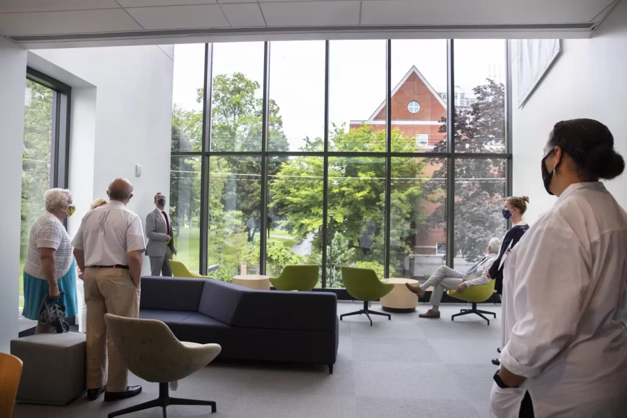 Tour goers stop by the light-filled lounge on the second level of Bonney Science Center, which offers a commanding view of campus through windows of the Beacon. (Phyllis Graber Jensen/Bates College)