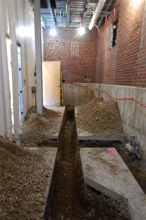 Note the trenches for subfloor utilities in this former mechanical space on the first floor of Dana Chemistry Hall. This area will eventually be divided between a kitchenette/office and mechanical space. (Doug Hubley/Bates College)
