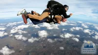 Gene Clough, lecturer emeritus in geology and physics, does a tandem skydive at SkyDive New England in Lebanon, Maine, on Oct. 11, 2021 (Photograph courtesy Shred Video)