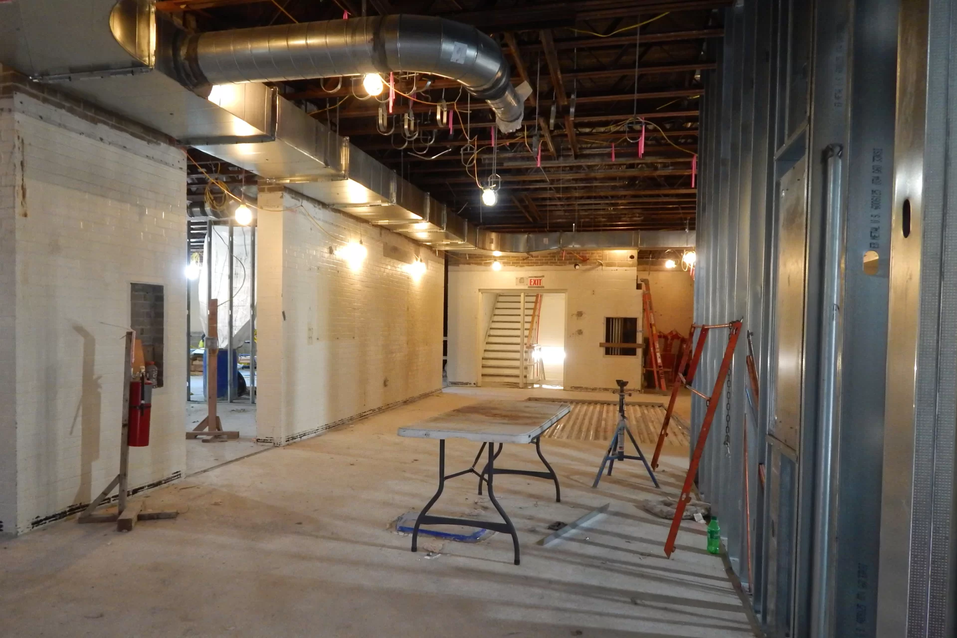 Dana Hall’s main entrance lobby. Note the steel decking right of center — the former site of restrooms, the steel will be infilled with concrete. The new restrooms are under construction out of the frame to the right. (Doug Hubley/Bates College)