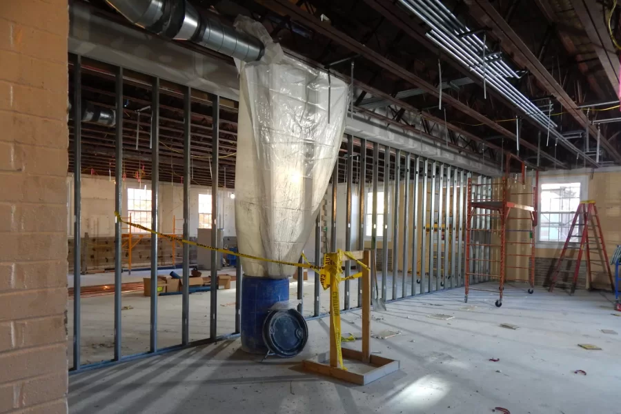 Under construction is a wall forming two active-learning classrooms on Dana's second floor. Note the new exhaust duct and electrical conduits along the ceiling. (Doug Hubley/Bates College)