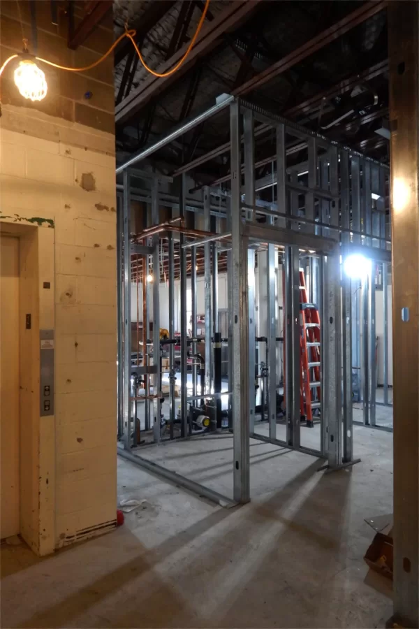 The metal wall studs on the second level of Dana indicate where new restrooms will be placed relative to the elevator on all three floors. ADA-compatible restrooms will be built to the left of the elevator. (Doug Hubley/Bates College)