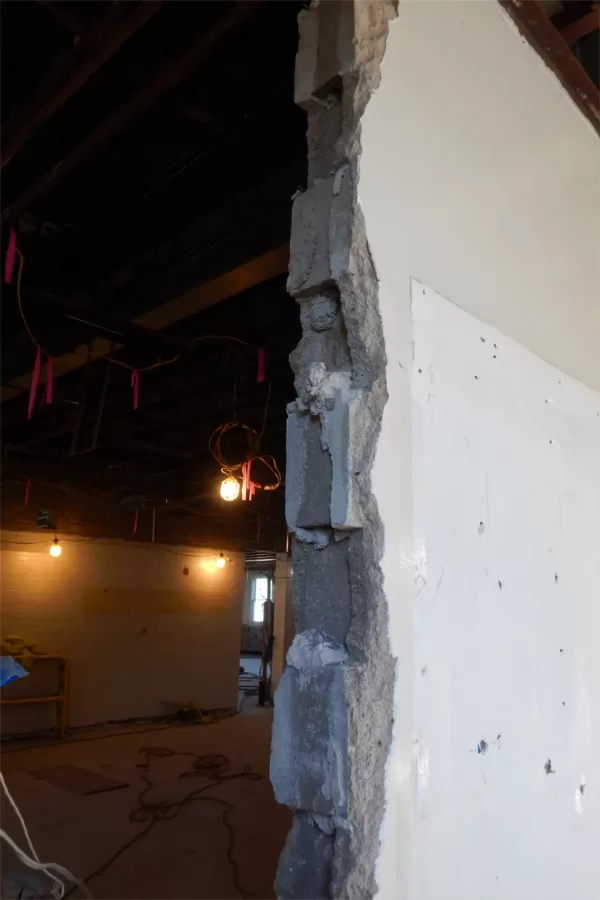 Much of the early work on the Dana Chemistry Hall project involved masonry demolition. This third-floor image shows where concrete blocks were removed to widen a doorway. (Doug Hubley/Bates College)