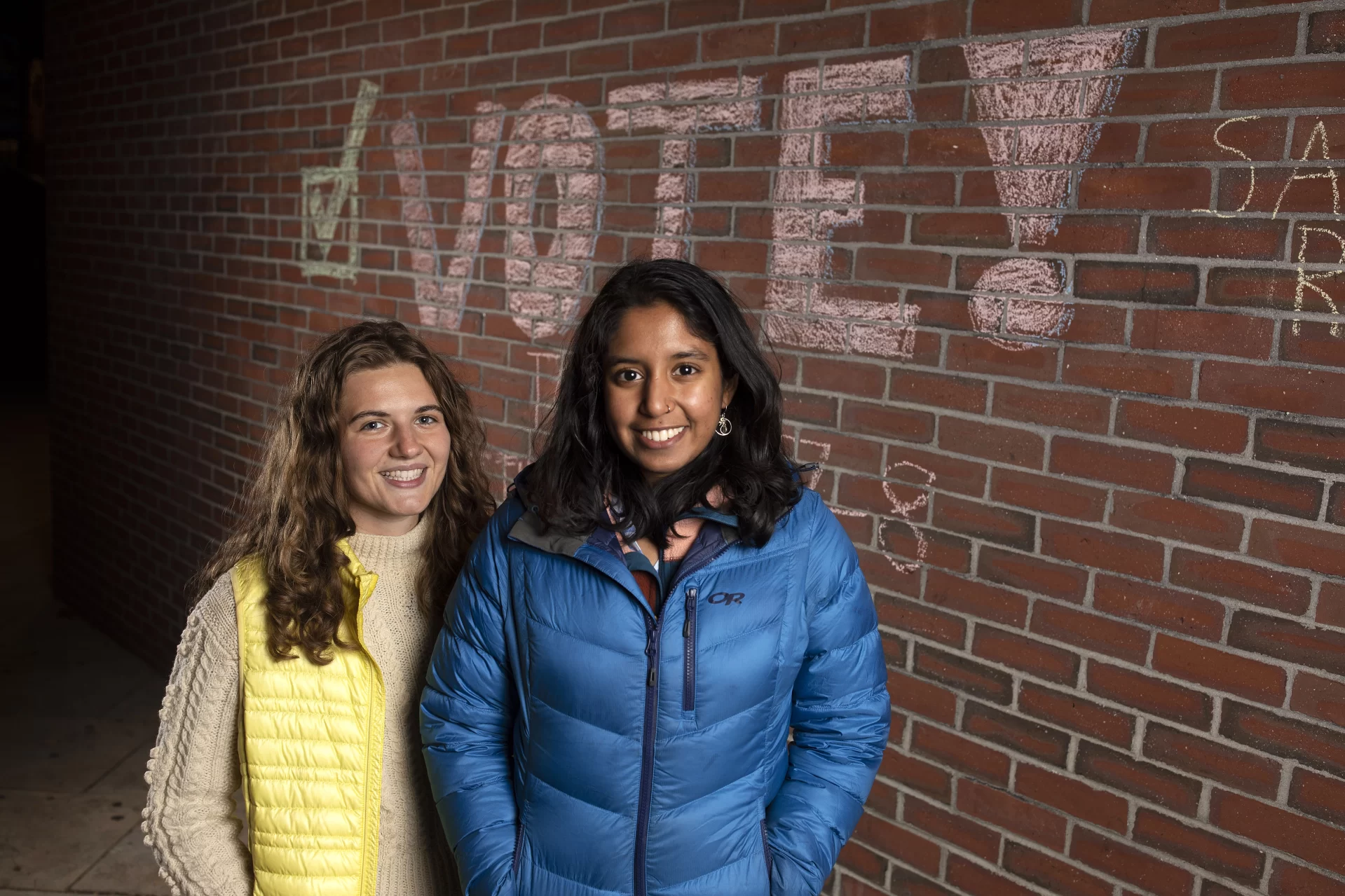 From left, Amalia Herren-Lage ’22 of Shoreham, Vt., and Ashka Jhaveri ’22 of Chappaqua, N.Y., pose in front of some chalking in the Library Aracade done to promote voting in the November 2021 election.

Bates was one of 48 colleges in the country recently honored for its outstanding student voting rate in the 2020 president election.

With 84.9 percent of eligible students heading to the polls in 2020, Bates garnered a platinum seal, awarded for voting rates over 80 percent by the ALL In Campus Democracy Challenge, a nonpartisan national awards program that recognizes colleges and universities for their commitment to increasing student voting. 

“The cultivation of ‘informed civic action’ is a pillar of our institutional mission,” said Darby Ray, director of the Harward Center for Community Partnerships, which oversees the nonpartisan voter mobilization effort, known as Bates Votes.

“Voting, including voter education, registration, and mobilization, is a crucial form of civic action and the very foundation of a thriving democracy.”

The 2020 edition of Bates Votes was coordinated by students Amalia Herren-Lage ’22 of Shoreham, Vt., and Ashka Jhaveri ’22 of Chappaqua, N.Y., with strategic support from Peggy Rotundo, who retired in 2021 as the Harward Center’s director of strategic and policy initiatives.
